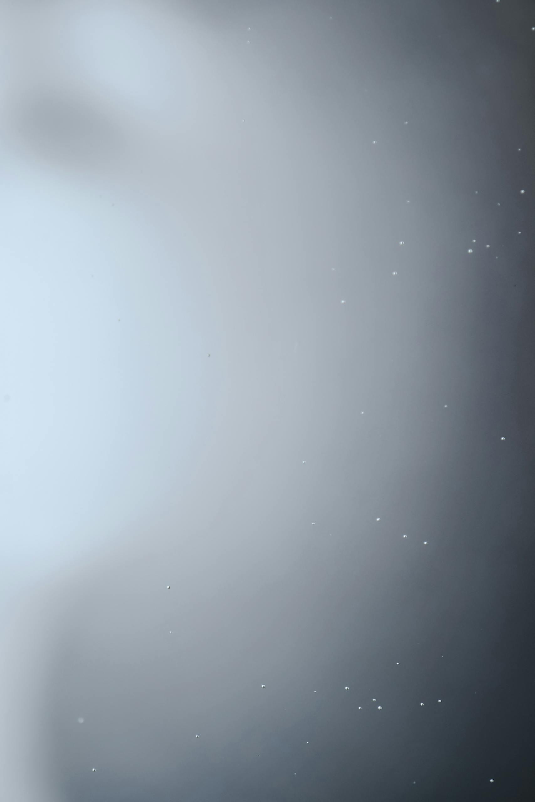 A blurred abstract background with soft lighting and a foggy appearance, perfect for design use.